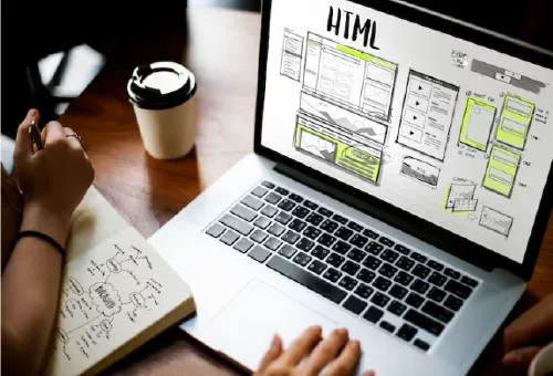 2 Women examining laptop