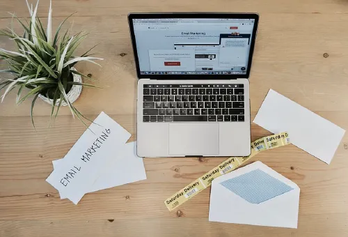 2 Women examining laptop