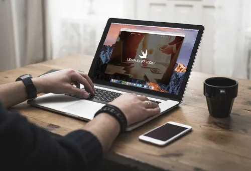 2 Women examining laptop